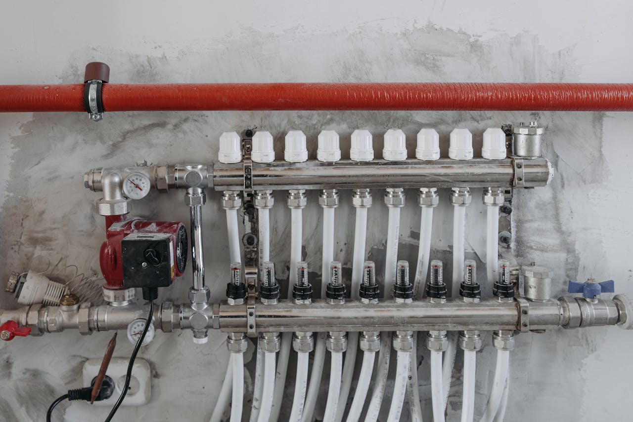 gallery-03 A close-up view of an industrial manifold with pressure gauges and connected steel pipes.